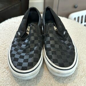 Vans black checkerboard slip-ons